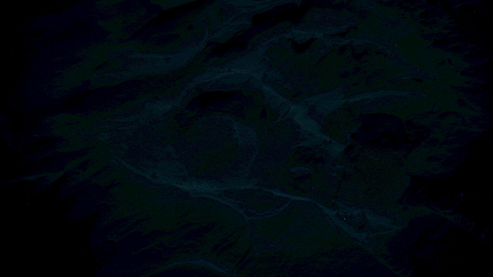 The image is very dark with indistinct and shadowy patterns, making it difficult to discern specific details or objects.